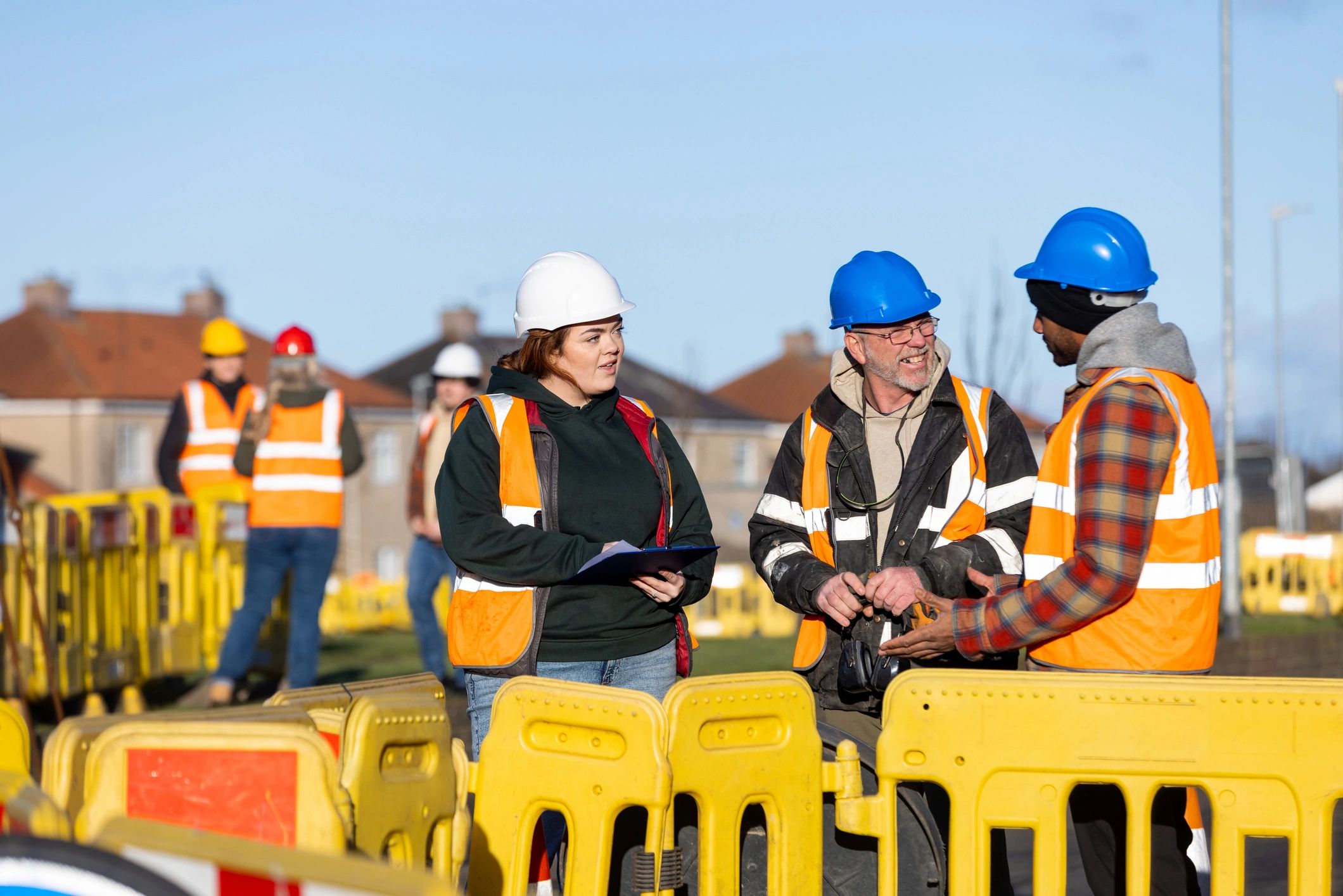 Engineers reviewing plans on an active construction site